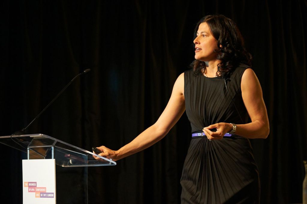 Maribel Lopez speaking on stage at a technology conference