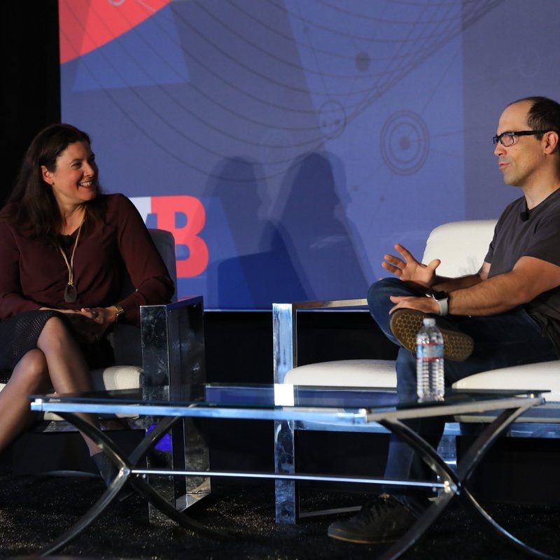 Maribel Lopez speaking on stage in conversation with a fellow speaker at an industry event